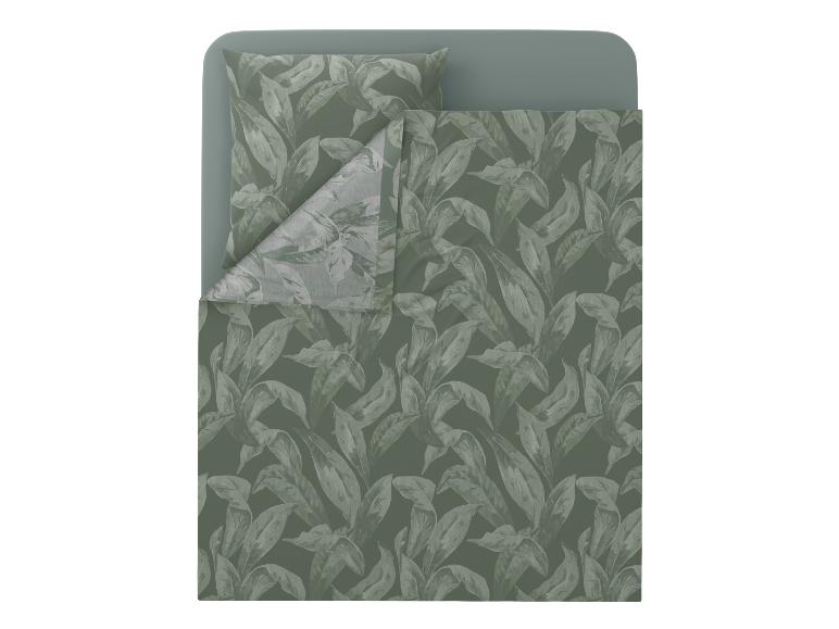 Parure de lit verte à motif de feuilles sur un lit.