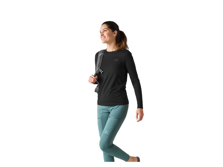 Femme en t-shirt noir à manches longues et leggings bleu-vert avec sac à dos.