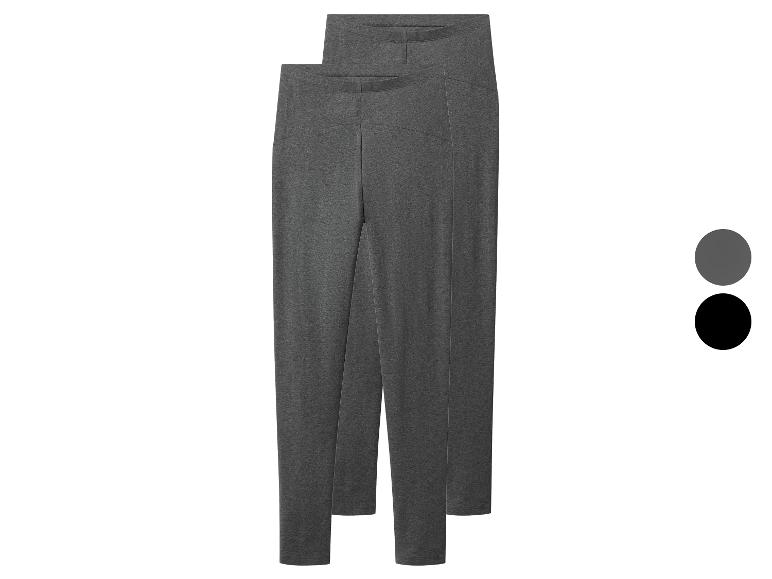 Deux paires de leggings gris foncé et noirs, positionnées l'une derrière l'autre.