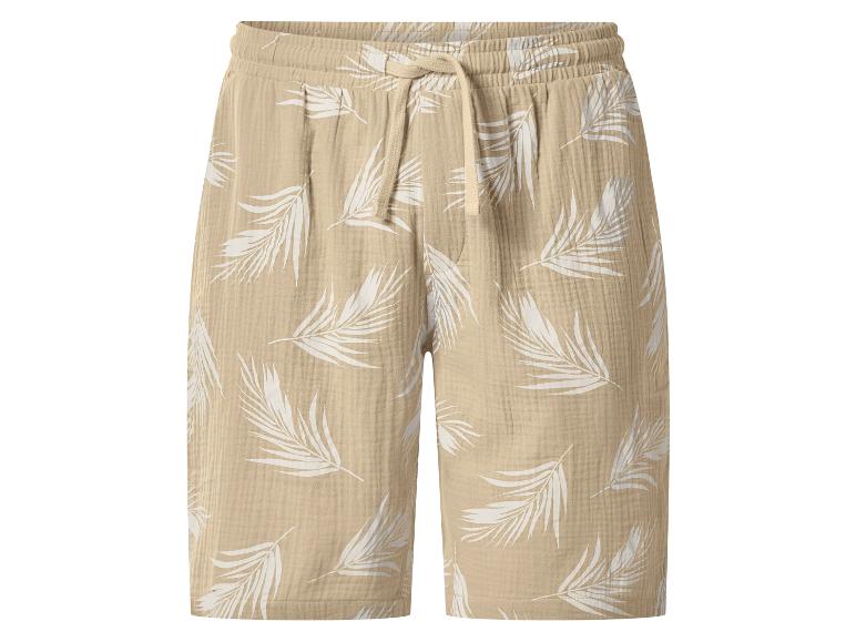 Shorts en mousseline beige avec imprimé feuilles blanches et cordon.
