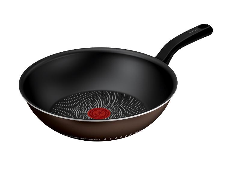 Poêle à frire avec intérieur noir et base marron, dotée d'une poignée et d'un indicateur de température.