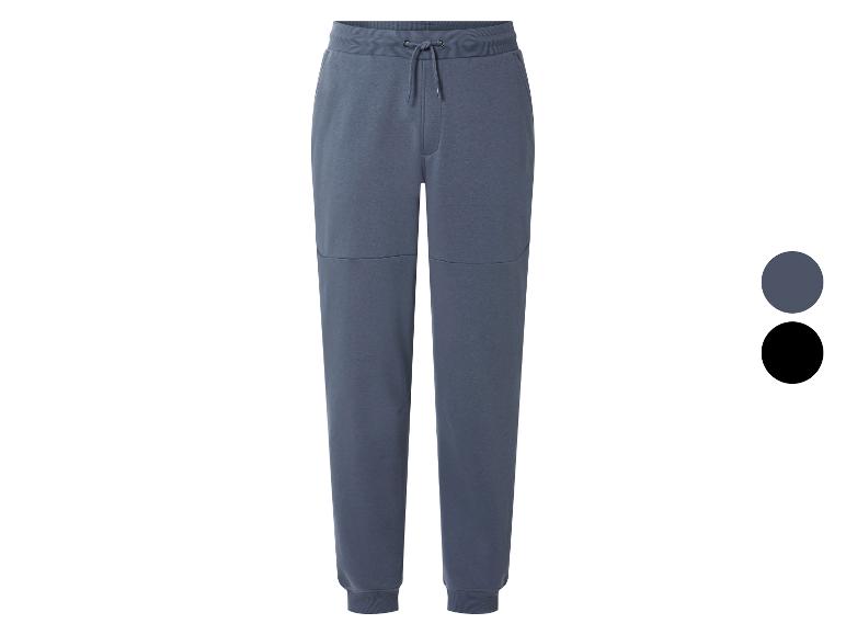 Pantalon de jogging homme gris-bleu avec cordon de serrage et poignets côtelés.