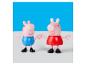 Deux figurines Peppa Pig, une en bleu et une en rouge, se tenant la main.
