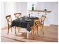 Une nappe noire à motif géométrique sur une table en bois avec des chaises.