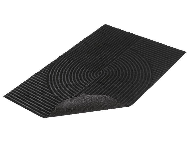 Tapis noir avec surface côtelée et motif abstrait