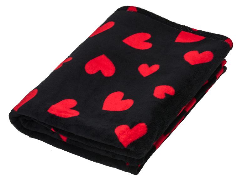 Couverture noire douce avec motif de cœurs rouges, pliée