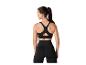Femme vue de dos portant leggings et top de sport noirs.