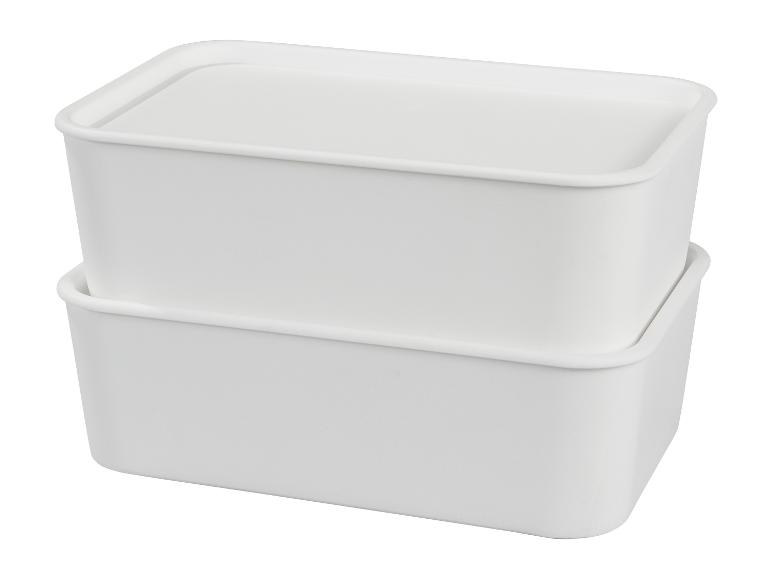 Deux boîtes de rangement blanches, rectangulaires, empilées, avec couvercles.