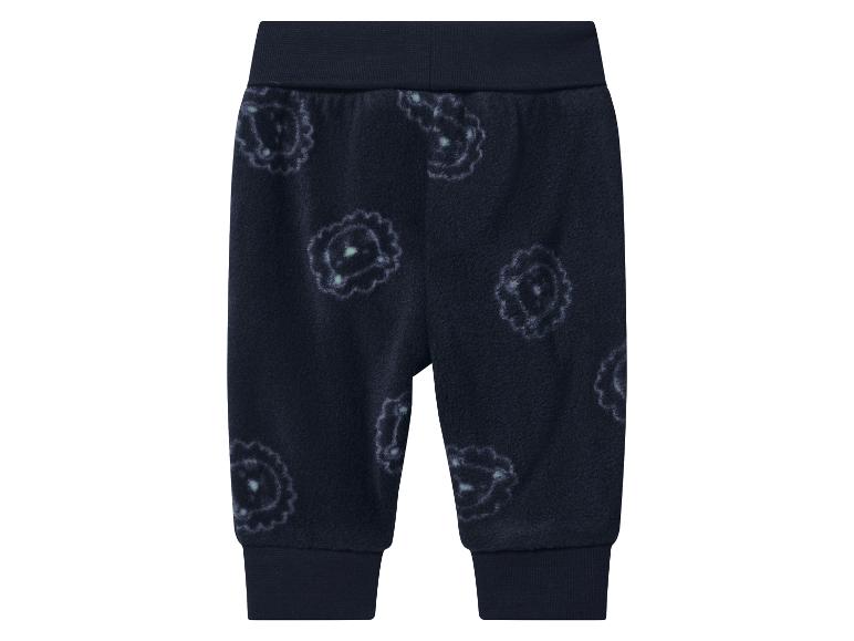 Pantalon de bébé bleu foncé avec un motif floral blanc et bleu clair.