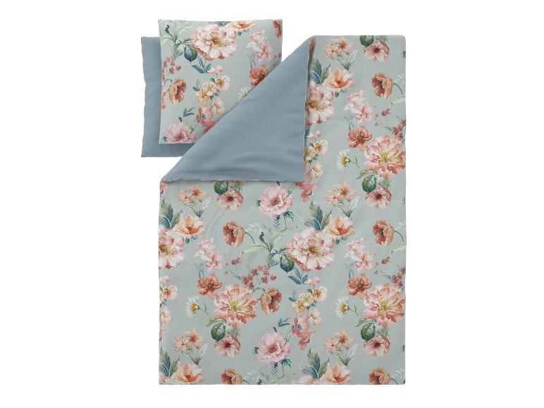 Parure de lit housse de couette et taie d'oreiller à motif floral pastel.