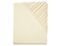 Un drap-housse beige avec élastique.