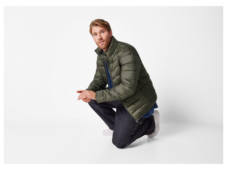 Homme en veste verte et jeans.