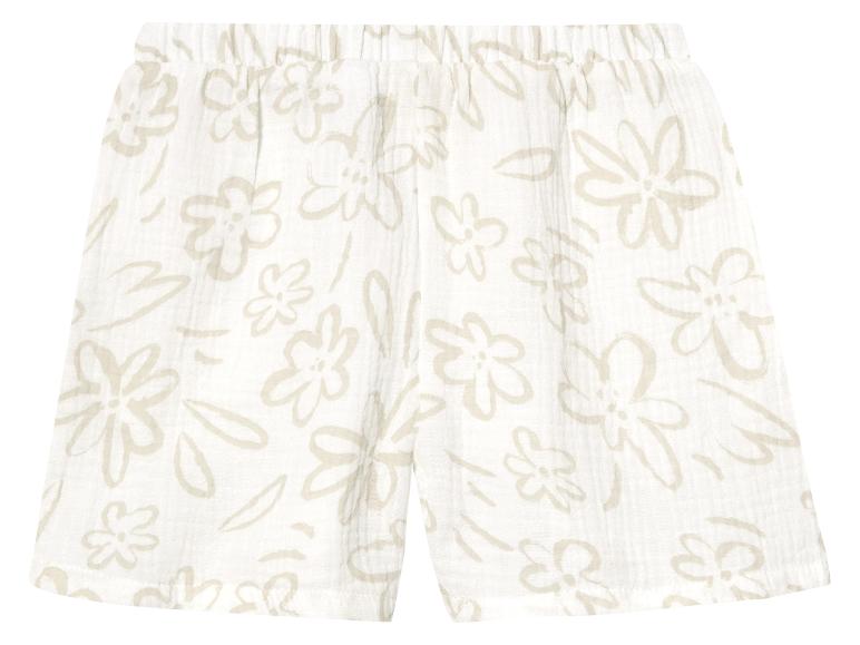 Shorts bébé, motif floral beige clair sur fond blanc.