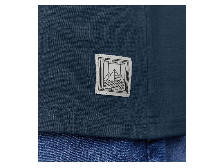 Un t-shirt bleu marine avec une étiquette indiquant 'Exploring New Adventures'.