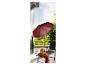 Un parasol rouge, une chaise longue et une petite table sur un balcon.