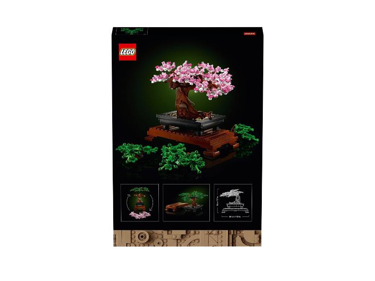 Une boîte avec un modèle LEGO d'un bonsaï avec des fleurs roses.