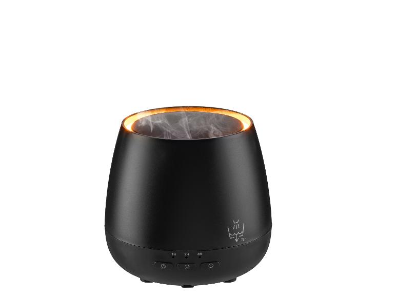 Un diffuseur d'arômes noir avec lumière orange et vapeur, avec boutons de commande.