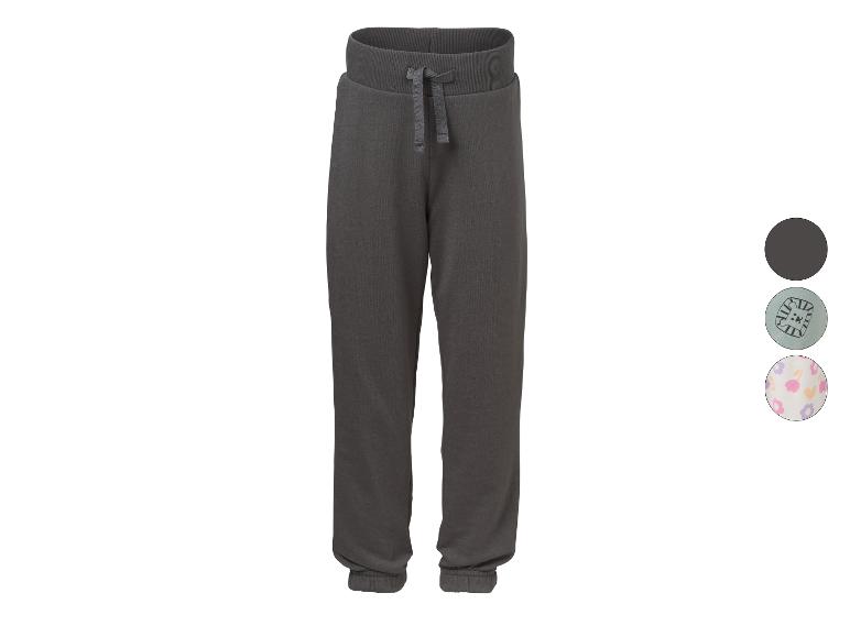 Pantalon de jogging gris foncé avec cordon de serrage, présenté avec deux options à motifs.