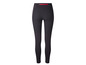 Leggings noirs avec une fermeture éclair rouge à l'arrière.