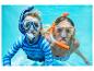 Deux enfants faisant de la plongée avec tuba sous l'eau, portant des t-shirts de bain et des bikinis.