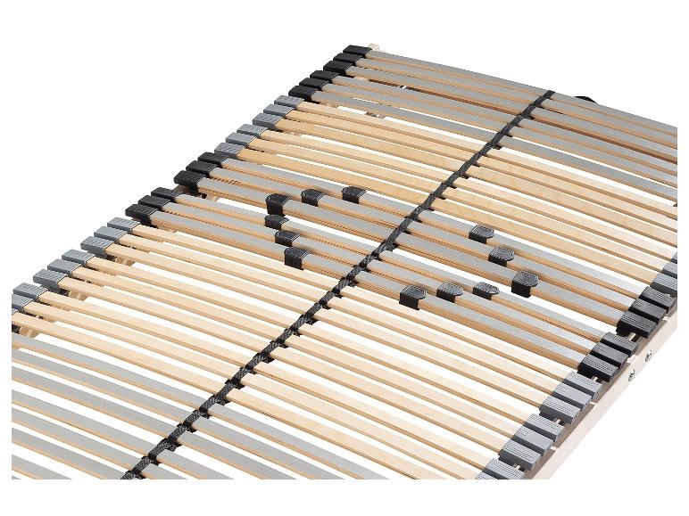 Un sommier à lattes en bois avec des fixations noires et grises.