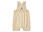 Une salopette beige avec de larges bretelles pour bébés.