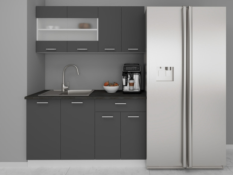 Une cuisine avec des armoires grises, un évier, une cafetière et un réfrigérateur.