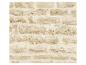 Mur de briques beige avec des pierres irrégulières et une texture rugueuse.