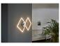 Deux appliques murales LED modernes en forme de losange, installées dans un salon.