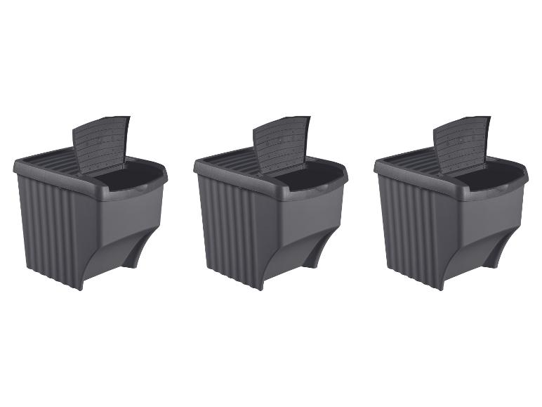 Trois bacs à compost gris foncé avec couvercles ouverts, disposés en rangée.