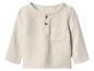 Haut enfant crème à manches longues avec boutons et poche.