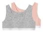 Deux brassières de sport pour filles, une grise et une rose.
