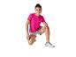 Haut rose et shorts de sport; chaussures de sport.