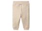 Pantalon bébé beige avec taille et poignets côtelés.