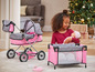 Une poussette rose à pois, un berceau et une poupée pour enfants.