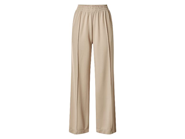 Pantalon large beige avec taille élastique.