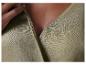 Détail d'une robe en lin vert olive, fermeture à boutons.