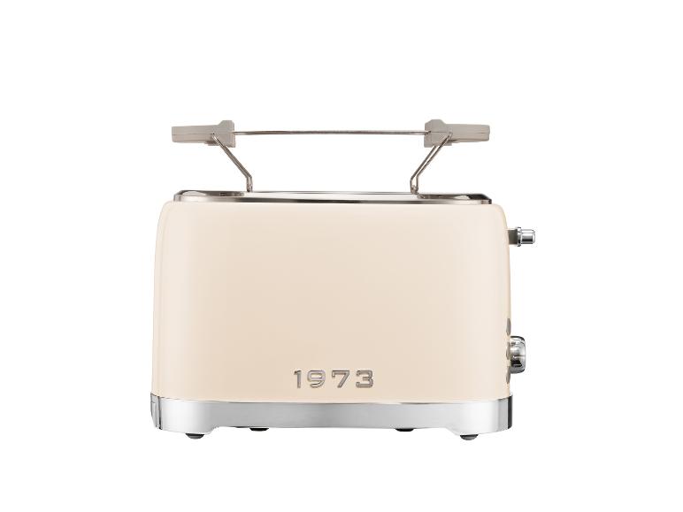 Grille-pain crème avec base et dessus métalliques, et le texte '1973' sur le devant.