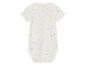 Un body blanc pour bébé avec des pois jaunes, roses et bleus.