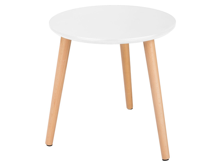 Une table basse ronde blanche avec des pieds en bois.