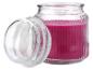 Bocal en verre ouvert avec une bougie parfumée rose.