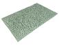 Un tapis de bain vert clair avec une texture douce et ronde.