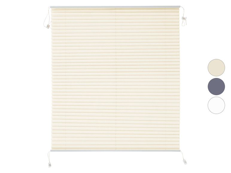 Un store plissé de couleur crème avec des cordons de traction blancs.