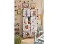Chambre d'enfant avec une armoire de rangement sur le thème de la forêt et des meubles.