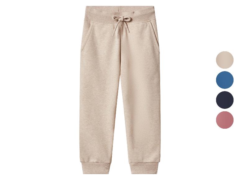 Pantalon de jogging beige avec cordon de serrage et poignets côtelés, avec échantillons de couleurs.