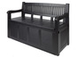Un banc de jardin en bois noir avec rangement.