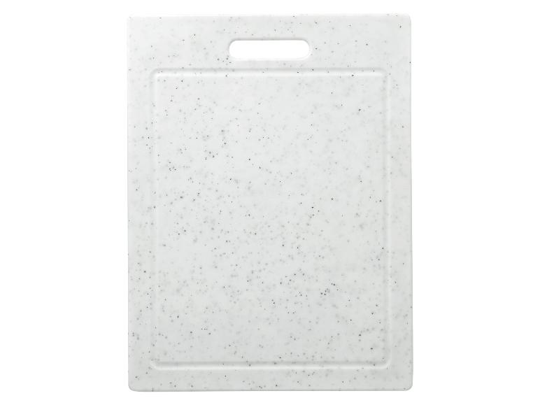 Planche à découper blanche mouchetée de noir avec poignée découpée