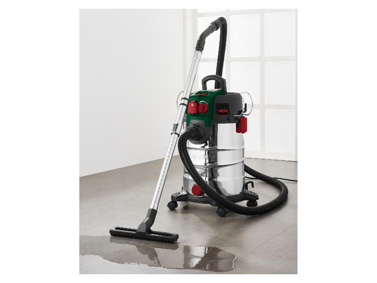 Aspirateur eau et poussière avec réservoir métallique, nettoyant une flaque d'eau.