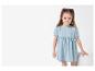 Petite fille portant une robe en jean bleu clair.