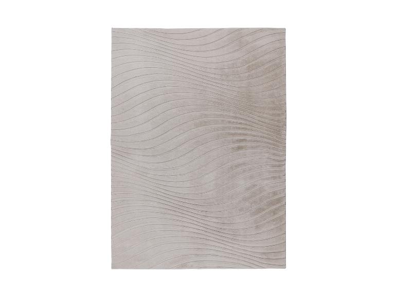 Tapis rectangulaire beige avec motif ondulé en relief.